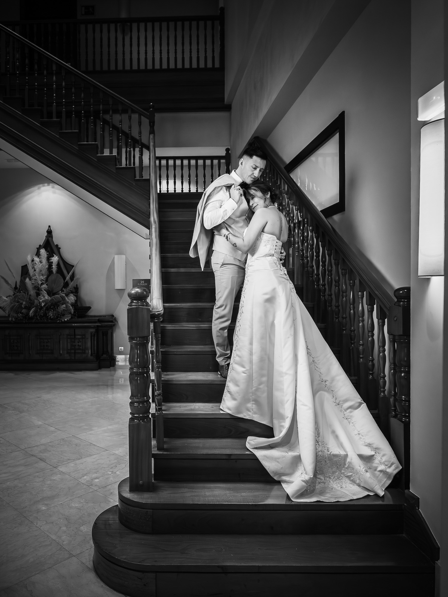 Artistic black and white B&W portrait of Bride and Groom on a staircase, at the venue.